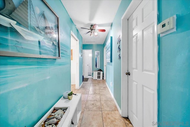 hall featuring light tile patterned flooring