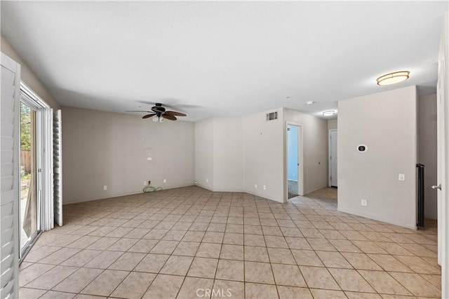 spare room featuring ceiling fan, light tile patterned flooring, and visible vents