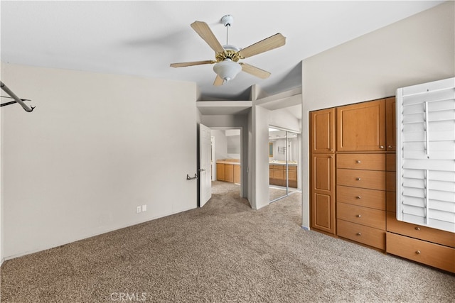 unfurnished bedroom with ceiling fan, light colored carpet, and a closet