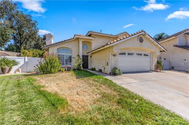 mediterranean / spanish-style home with driveway, a chimney, fence, a garage, and stucco siding