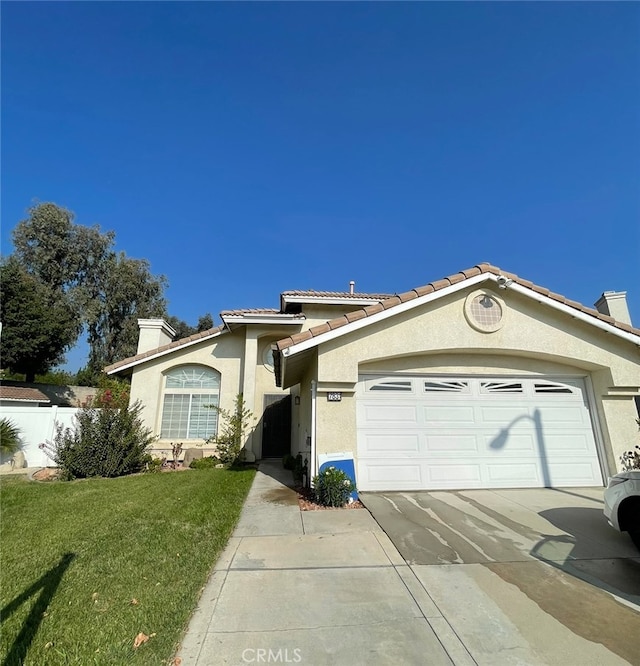 view of front of property featuring a front yard and a garage