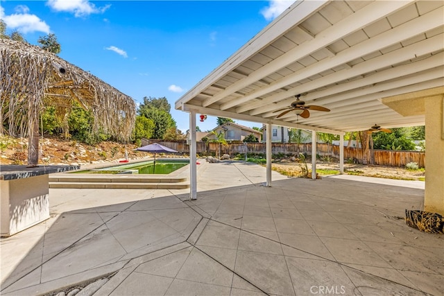 view of patio with a pool and ceiling fan