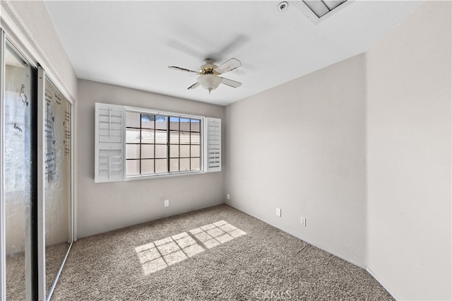 unfurnished bedroom with carpet floors, a closet, and ceiling fan