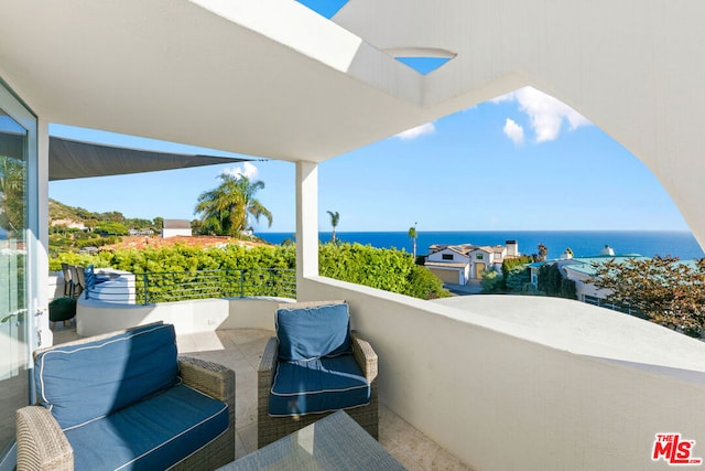 balcony featuring a water view