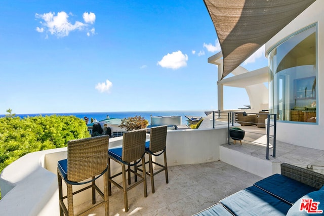 balcony featuring a water view