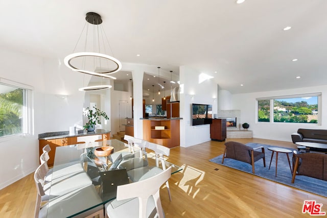 dining space with a notable chandelier and light hardwood / wood-style flooring