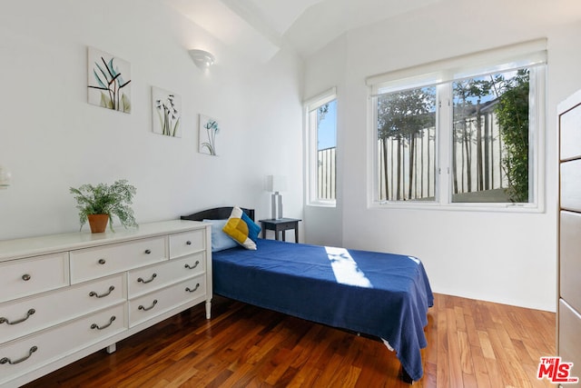 bedroom with dark hardwood / wood-style flooring