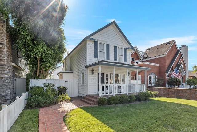 front facade with a front lawn and a porch