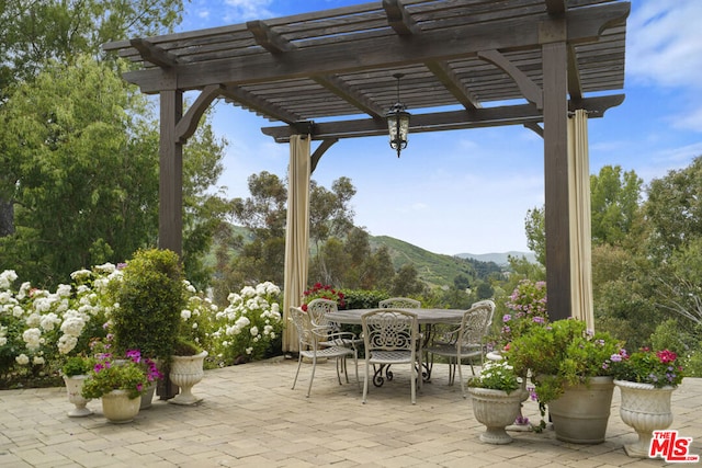 view of patio with a pergola and a mountain view