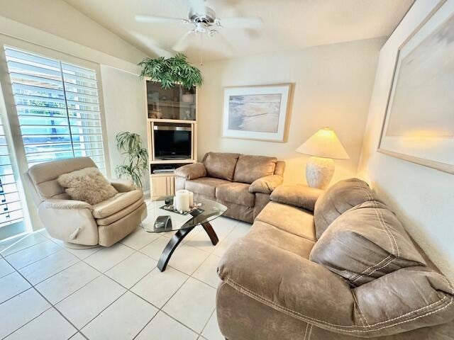 living room featuring vaulted ceiling, ceiling fan, and tile patterned floors