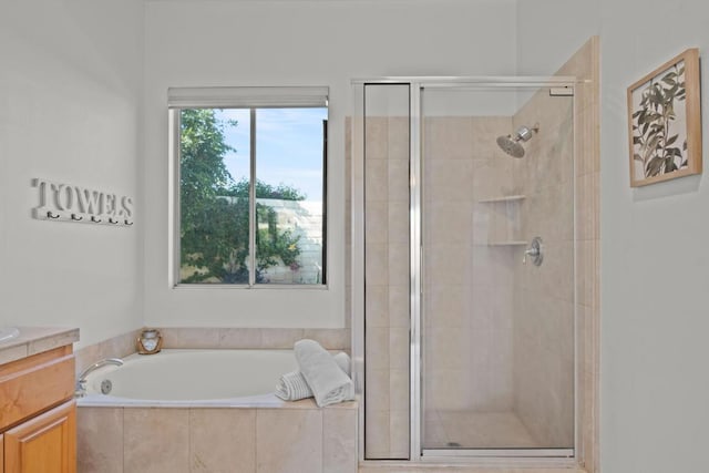 bathroom featuring plus walk in shower and vanity