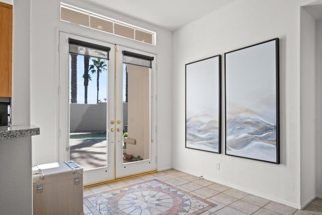 entryway featuring french doors and light tile patterned floors