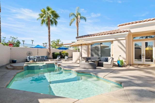 view of swimming pool with french doors and a patio