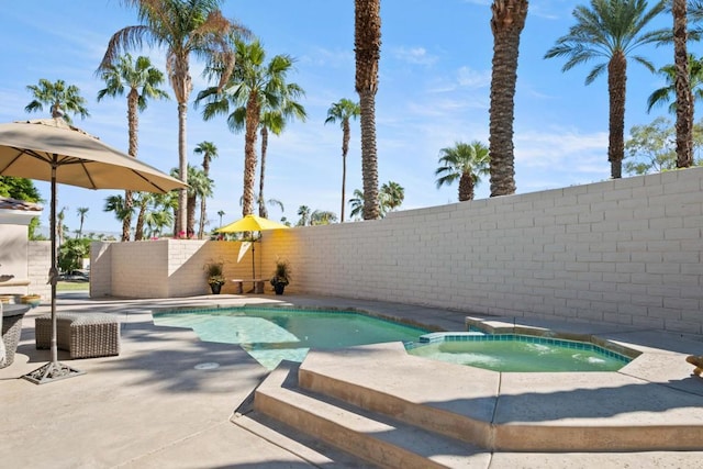 view of swimming pool featuring an in ground hot tub