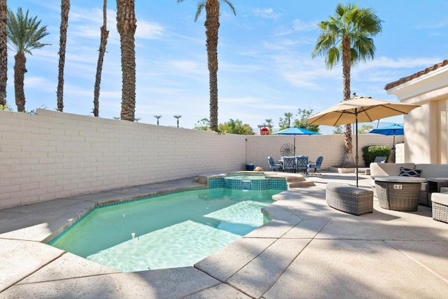 view of pool featuring an in ground hot tub and a patio