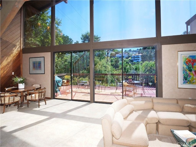 living room with high vaulted ceiling