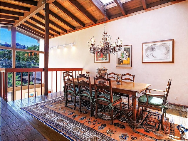 dining area with vaulted ceiling with beams and a notable chandelier