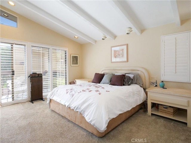 carpeted bedroom with vaulted ceiling with beams and access to outside