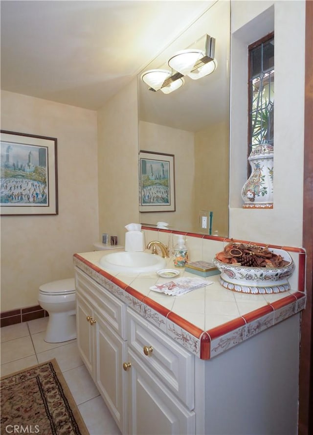 bathroom featuring toilet, vanity, and tile patterned floors