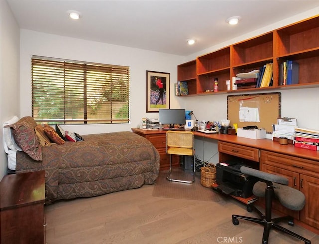 office space featuring built in desk and hardwood / wood-style flooring