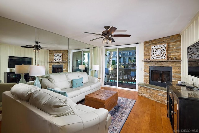 living room with ceiling fan, light hardwood / wood-style floors, and a fireplace