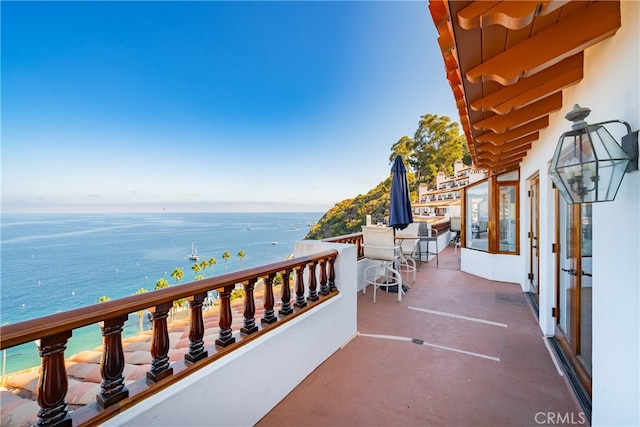 balcony featuring a water view