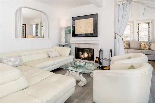 42 Camino De Flores Unit 60, Avalon, CA 90704 - living area featuring a tiled fireplace, wood finished floors, and beamed ceiling