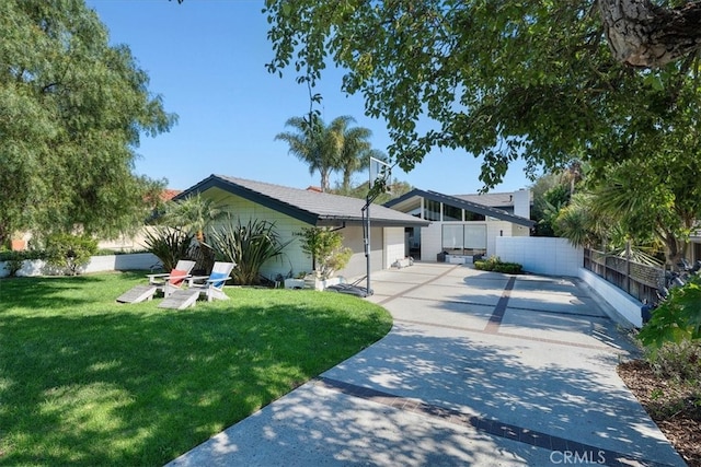 view of front of house with a front lawn and a garage