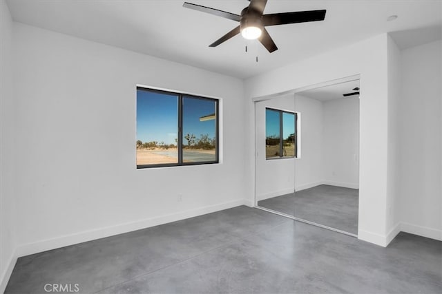 empty room featuring ceiling fan and a wealth of natural light