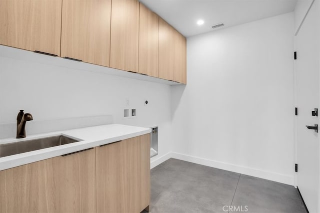 clothes washing area featuring cabinets, electric dryer hookup, washer hookup, and sink