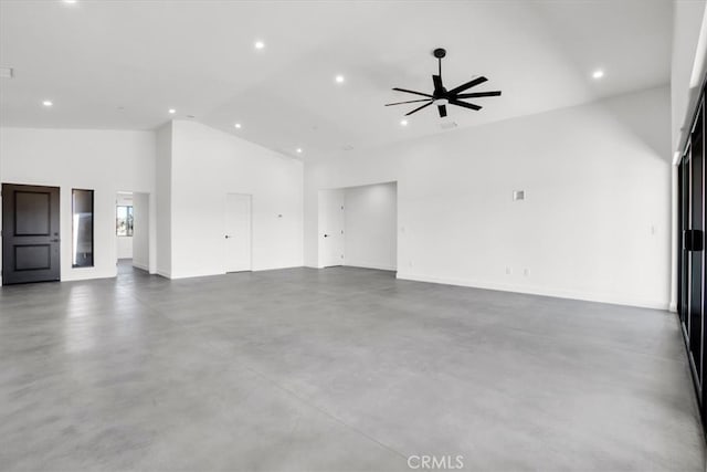 unfurnished living room featuring high vaulted ceiling, concrete flooring, and ceiling fan