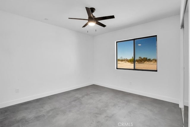 spare room featuring concrete flooring and ceiling fan