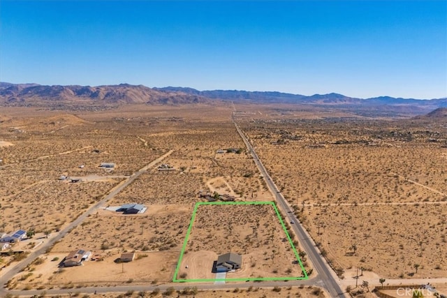 birds eye view of property with a mountain view