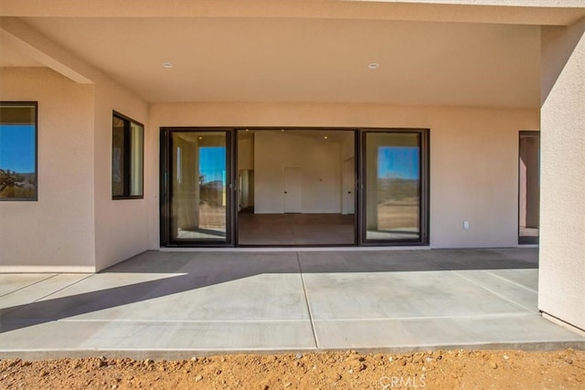 view of exterior entry featuring a patio