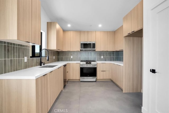 kitchen featuring decorative backsplash, appliances with stainless steel finishes, light brown cabinets, and sink