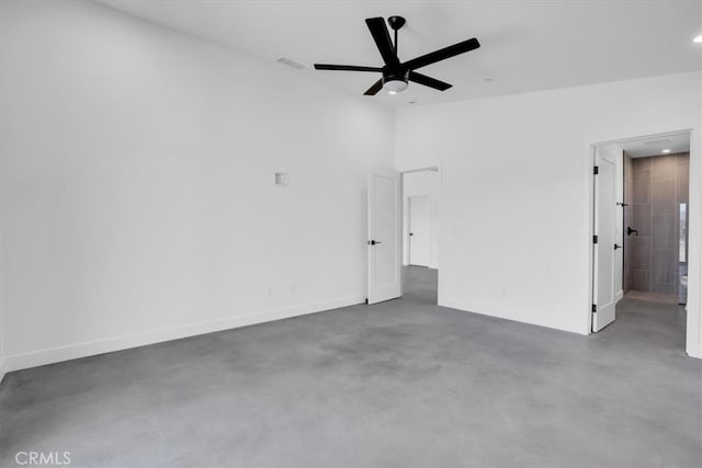 spare room featuring concrete floors and ceiling fan