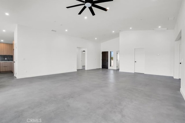 unfurnished living room featuring high vaulted ceiling and ceiling fan