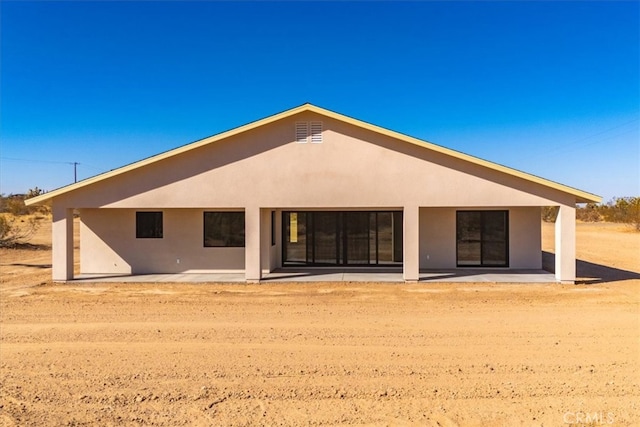 back of house with a patio