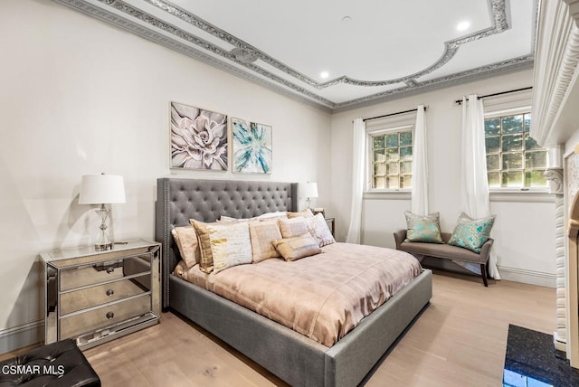 bedroom with wood-type flooring and crown molding