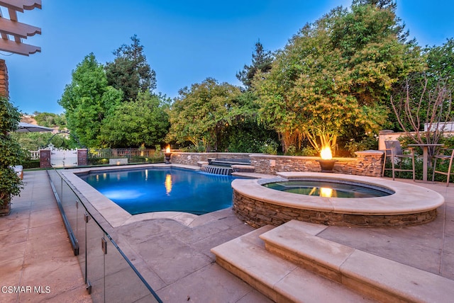 view of pool with a patio and an in ground hot tub