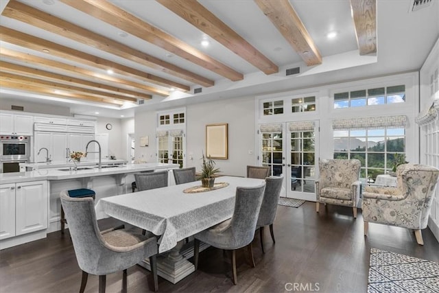 dining space featuring french doors, beamed ceiling, dark hardwood / wood-style floors, and sink