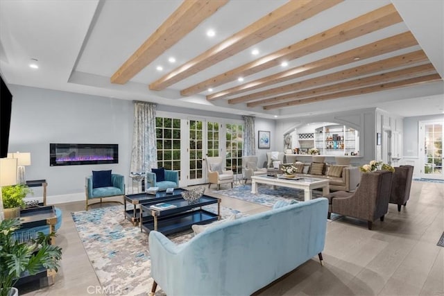 living room with beam ceiling and light hardwood / wood-style flooring