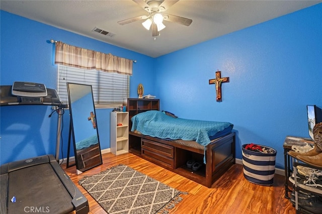 bedroom featuring ceiling fan and hardwood / wood-style flooring