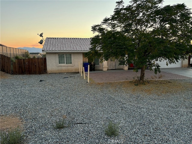 view of front of house with a garage and a patio area