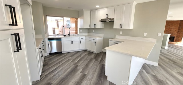 kitchen with light wood-type flooring, sink, kitchen peninsula, white cabinetry, and dishwasher