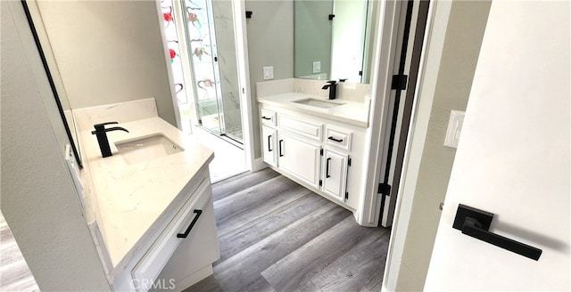 bathroom featuring vanity, hardwood / wood-style floors, and an enclosed shower