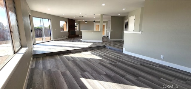 unfurnished living room with dark hardwood / wood-style floors