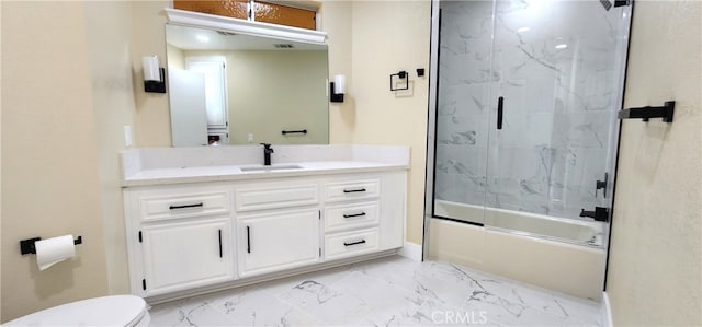 full bathroom featuring vanity, combined bath / shower with glass door, and toilet