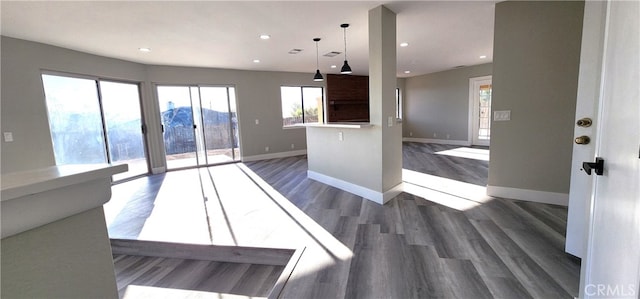 kitchen with hanging light fixtures and dark hardwood / wood-style floors