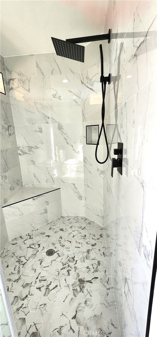 bathroom with tiled shower